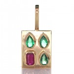 A Ruby With Three Green Sapphires Placed On A Gold Pendant