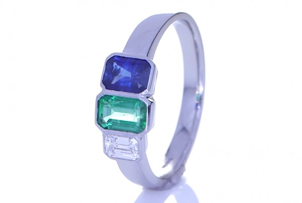 Green Sapphire, Blue Sapphire And A Diamond Placed On A Silver Ring