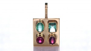 Two Green Sapphire And Two Rubies Placed On A Gold Pendant