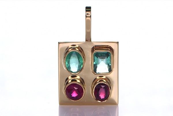 Two Green Sapphire And Two Rubies Placed On A Gold Pendant