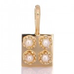 Four White Pearls Placed On a Golden Pendant 