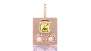 Two White Pearls With A Golden Sapphire Placed On A Golden Pendant