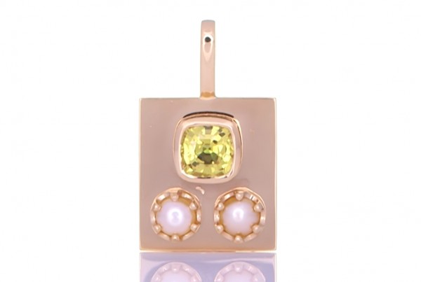 Two White Pearls With A Golden Sapphire Placed On A Golden Pendant