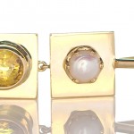 Yellow Sapphire And A White Pearl Placed On Individual Golden Pendant