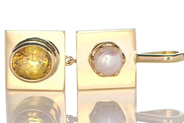 Yellow Sapphire And A White Pearl Placed On Individual Golden Pendant