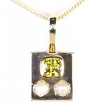Yellow Sapphire With Two White pearls Placed On A Golden Pendant