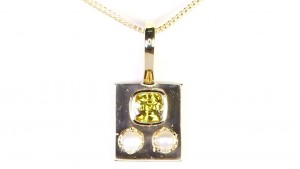 Yellow Sapphire With Two White pearls Placed On A Golden Pendant