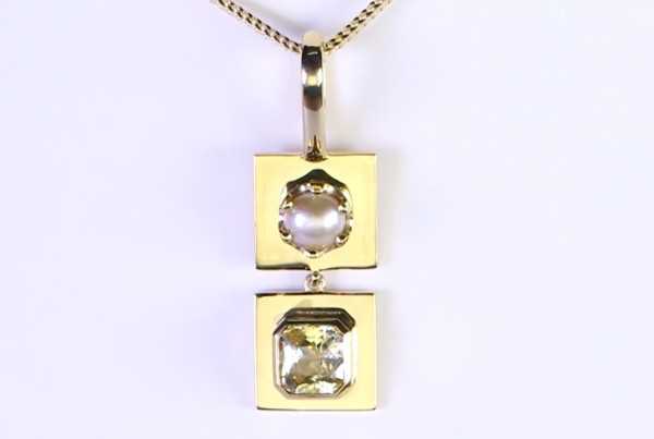 Golden Sapphire With White Pearl On A Golden Pendant