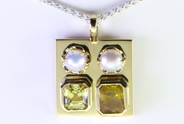 Two White Pearls With A Yellow And Golden Sapphires On A Golden Pendant 