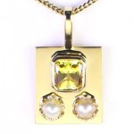 Two White Pearls With A Yellow Sapphire On A Golden Pendant
