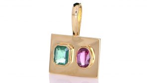 Green Emerald With Ruby Mounted Onto A Golden Pendant