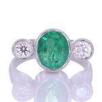 Platinum Ring With Two Diamonds And A Green Sapphire
