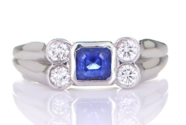 Four Diamonds With A Blue Sapphire Mounted On A Platinum Ring