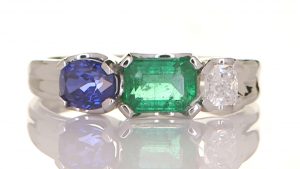 Platinum Ring With A Blue Sapphire, Diamond And An Emerald