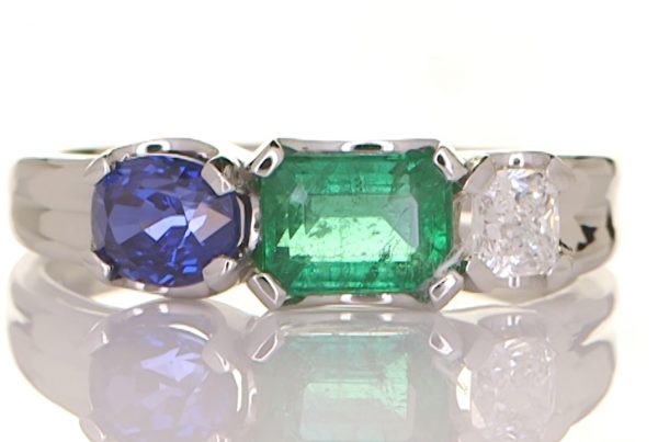 Platinum Ring With A Blue Sapphire, Diamond And An Emerald
