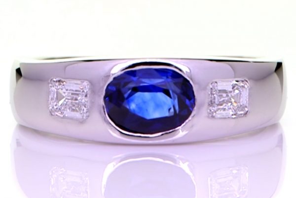 Oval Shape Blue Sapphire With 2 Emerald Cut Diamonds, Set In Platiumnium Thick Band